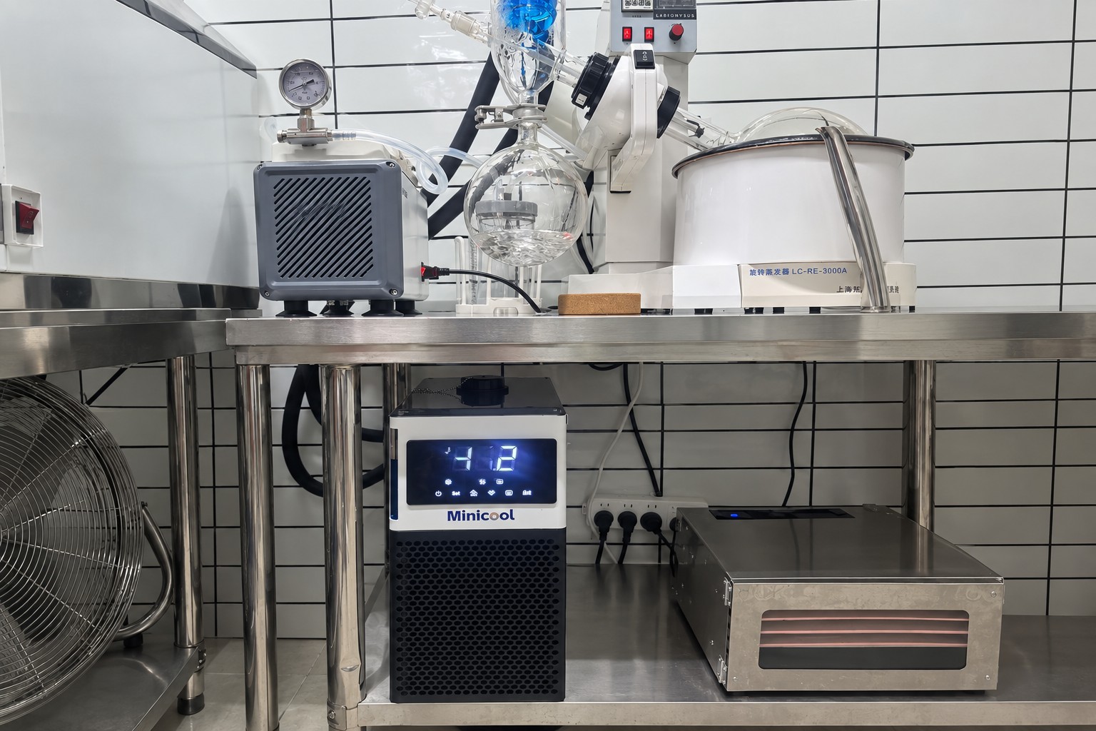 MiniCool recirculating chiller installed under a laboratory bench below a rotary evaporator