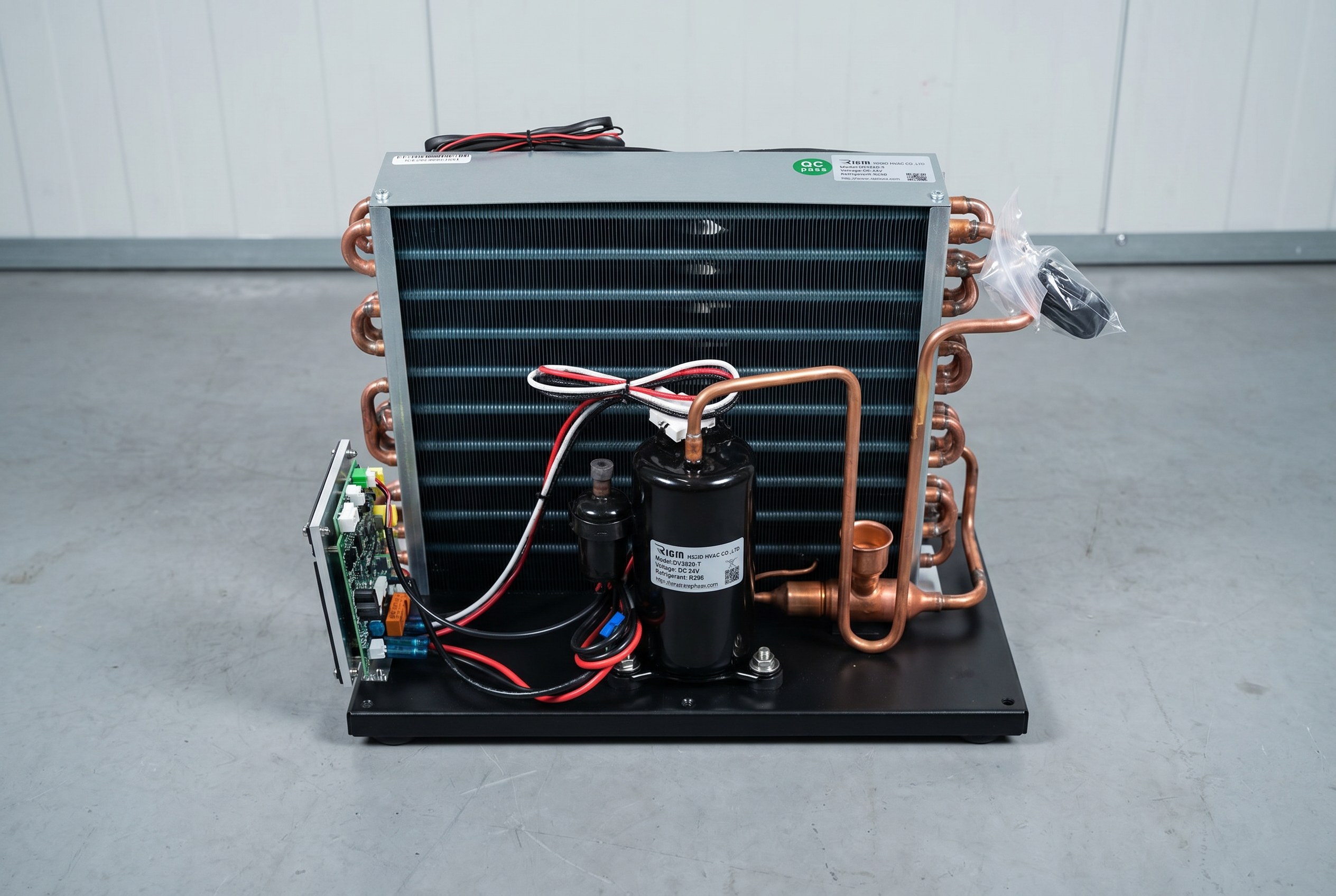 DC condensing unit installed outside a small cold room with copper refrigerant lines routed through insulated wall